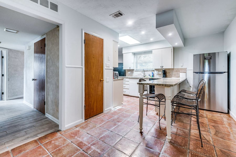 Warm tiles, granite tops, and good vibes -- this kitchen feels like home 