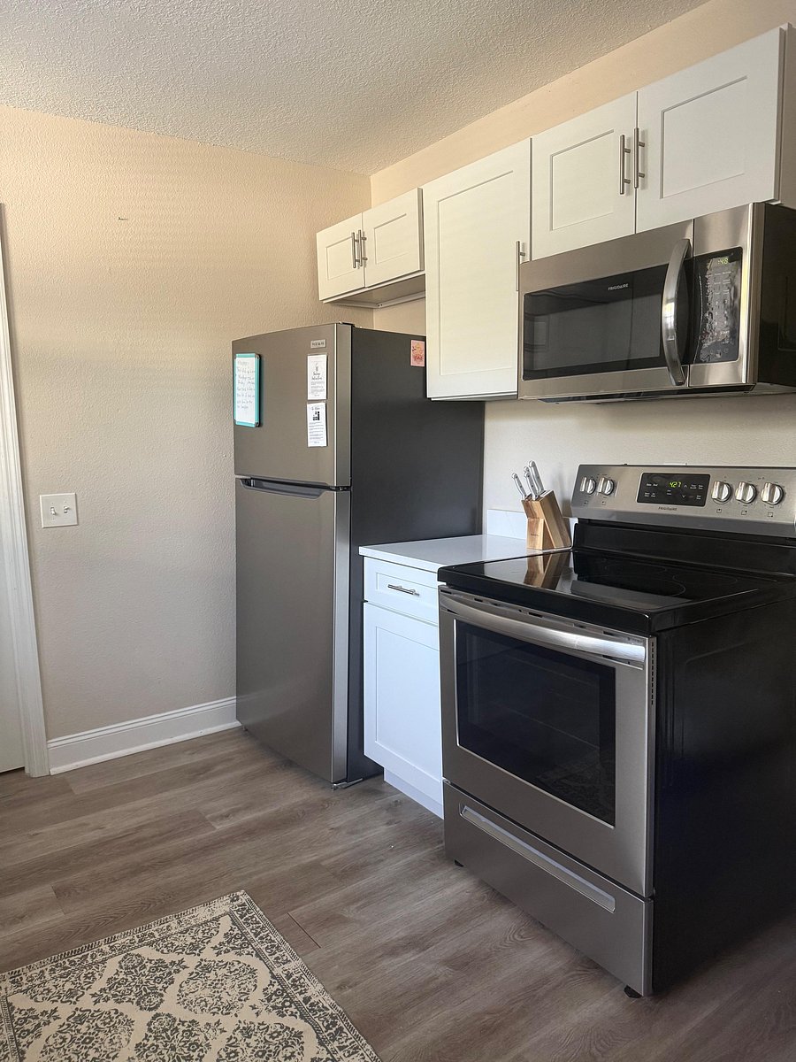 Stove and fridge and microwave in kitchen