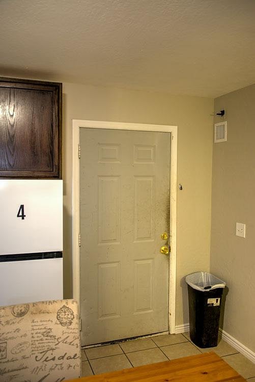 Entry area with tiled flooring, nearby storage cabinetry, and easy access to adjacent living space.