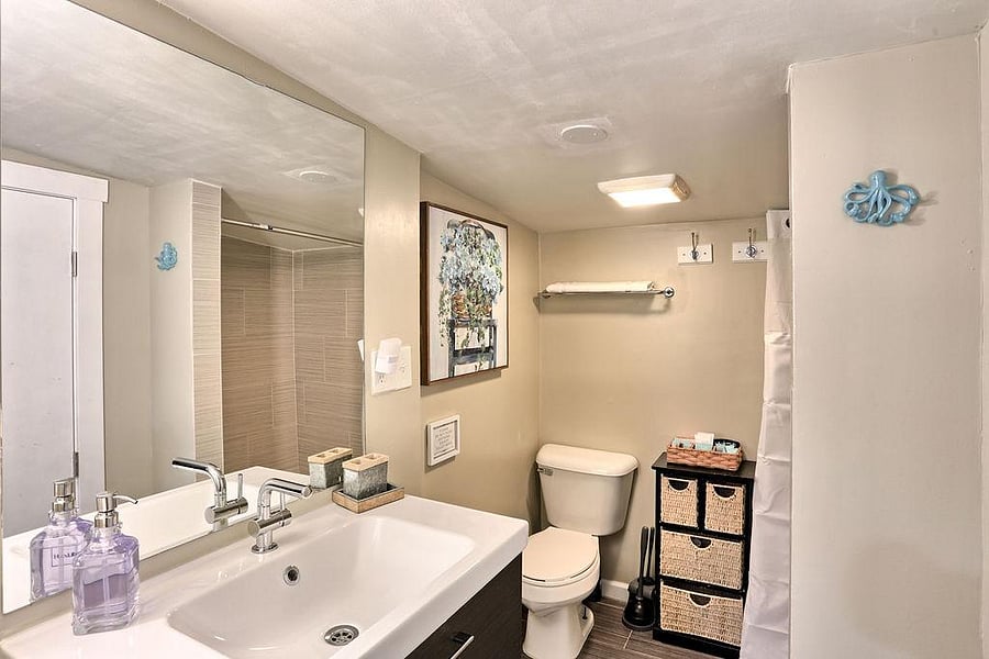 Modern bathroom with bathtub shared in the hallway.