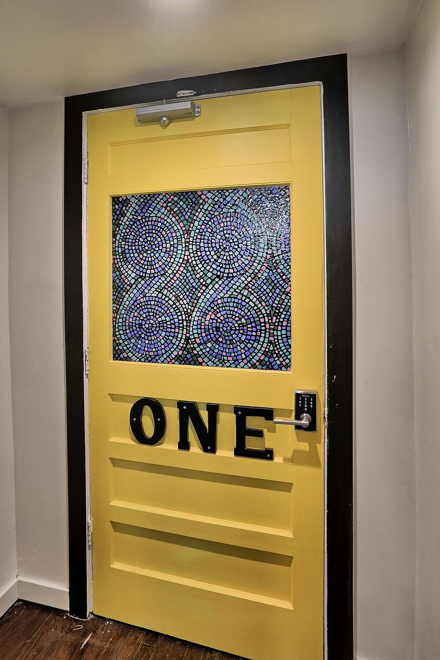 Two full size bedrooms and two king size bedrooms are located behind the bright yellow door labeled "One".