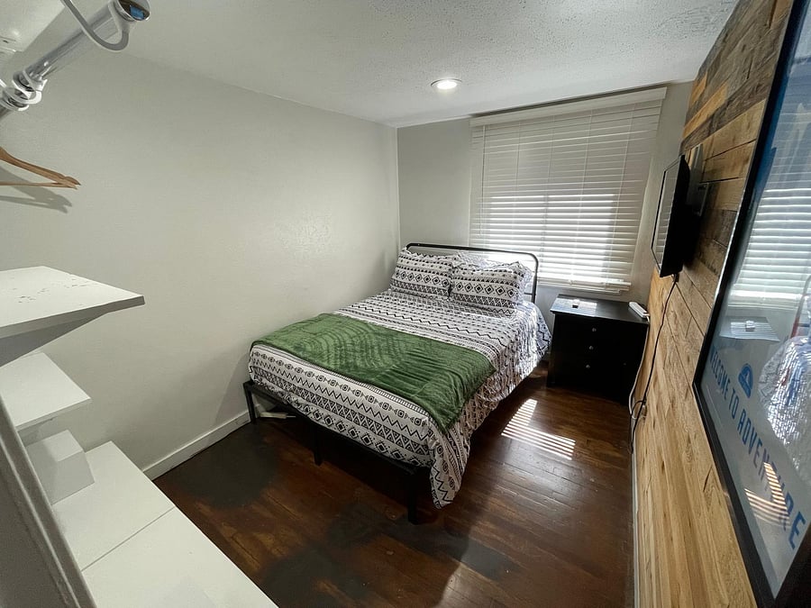 Your cozy room features a full size bed with a mounted tv.