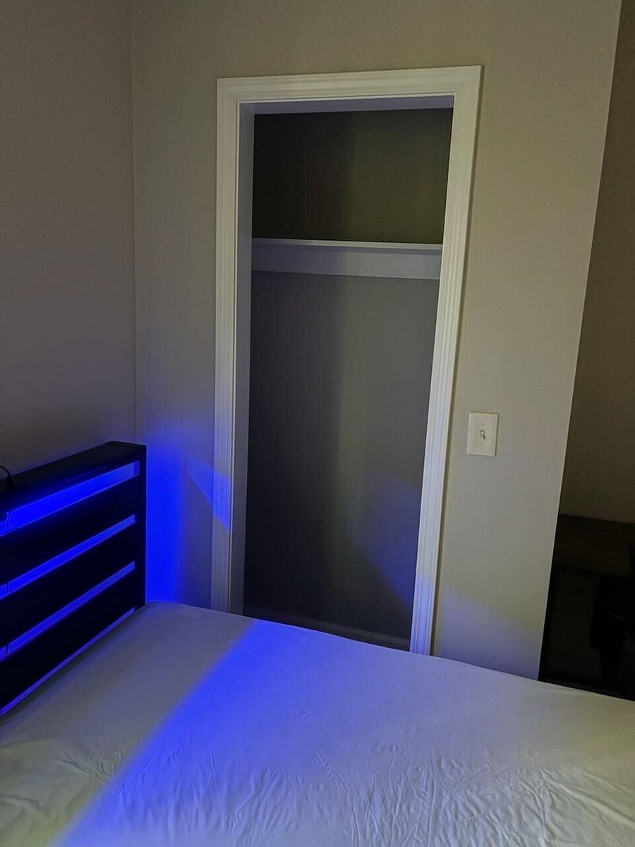 Private bedroom with space for a full/queen bed and an open closet for easy storage and organization.