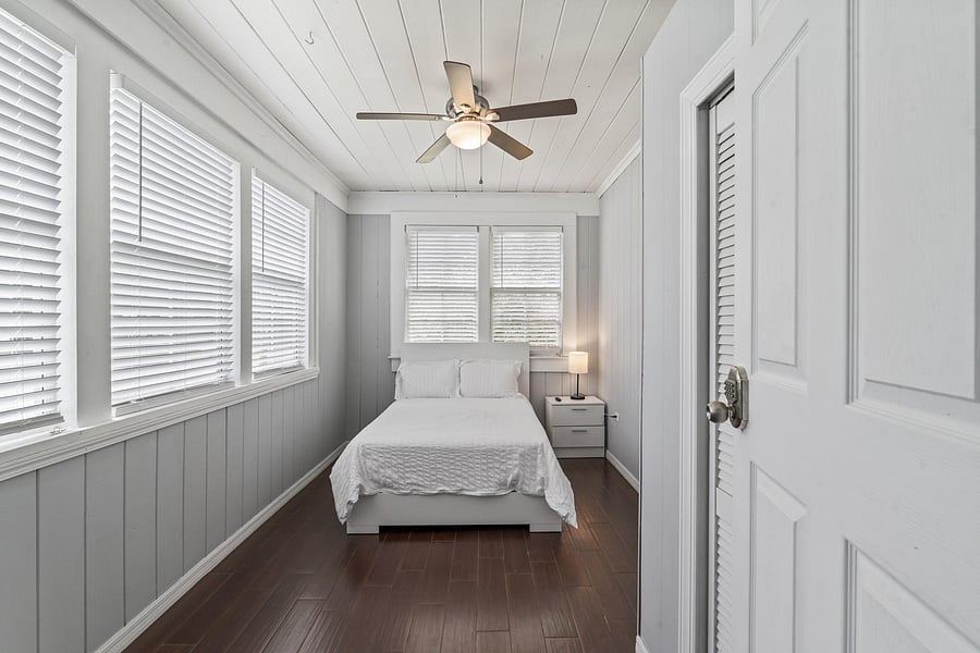 This room includes a TV and ceiling fan