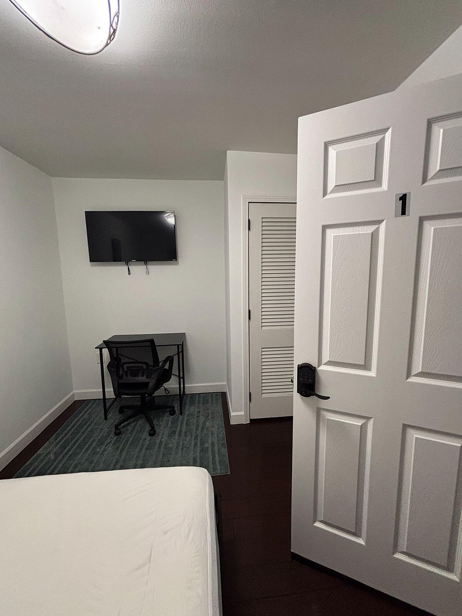 Television, desk, and closet.