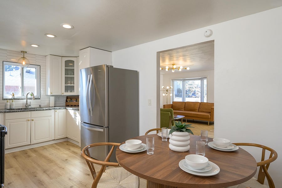 Kitchen table, kitchen, and view of the main floor living room.