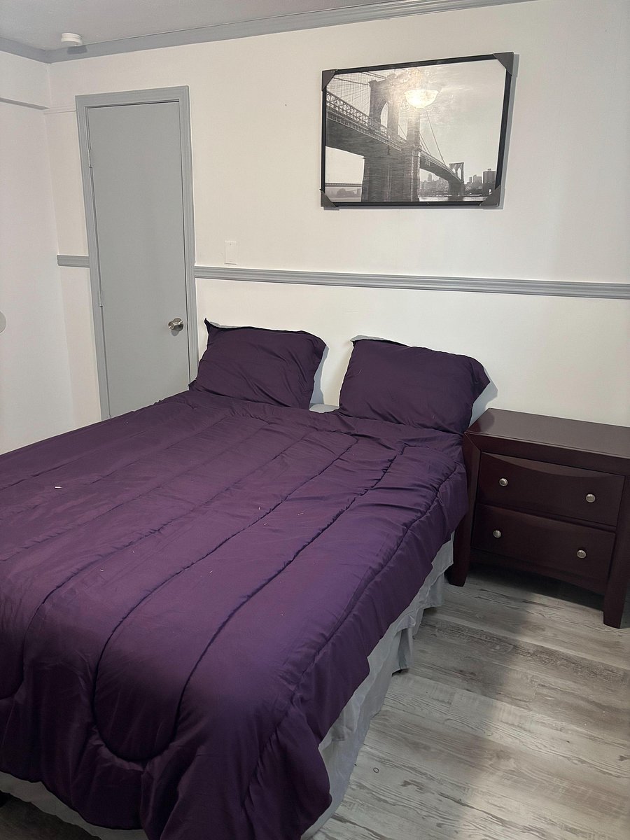Furnished bedroom with a full bed, nightstand, and easy access to the closet/entry door for everyday convenience.