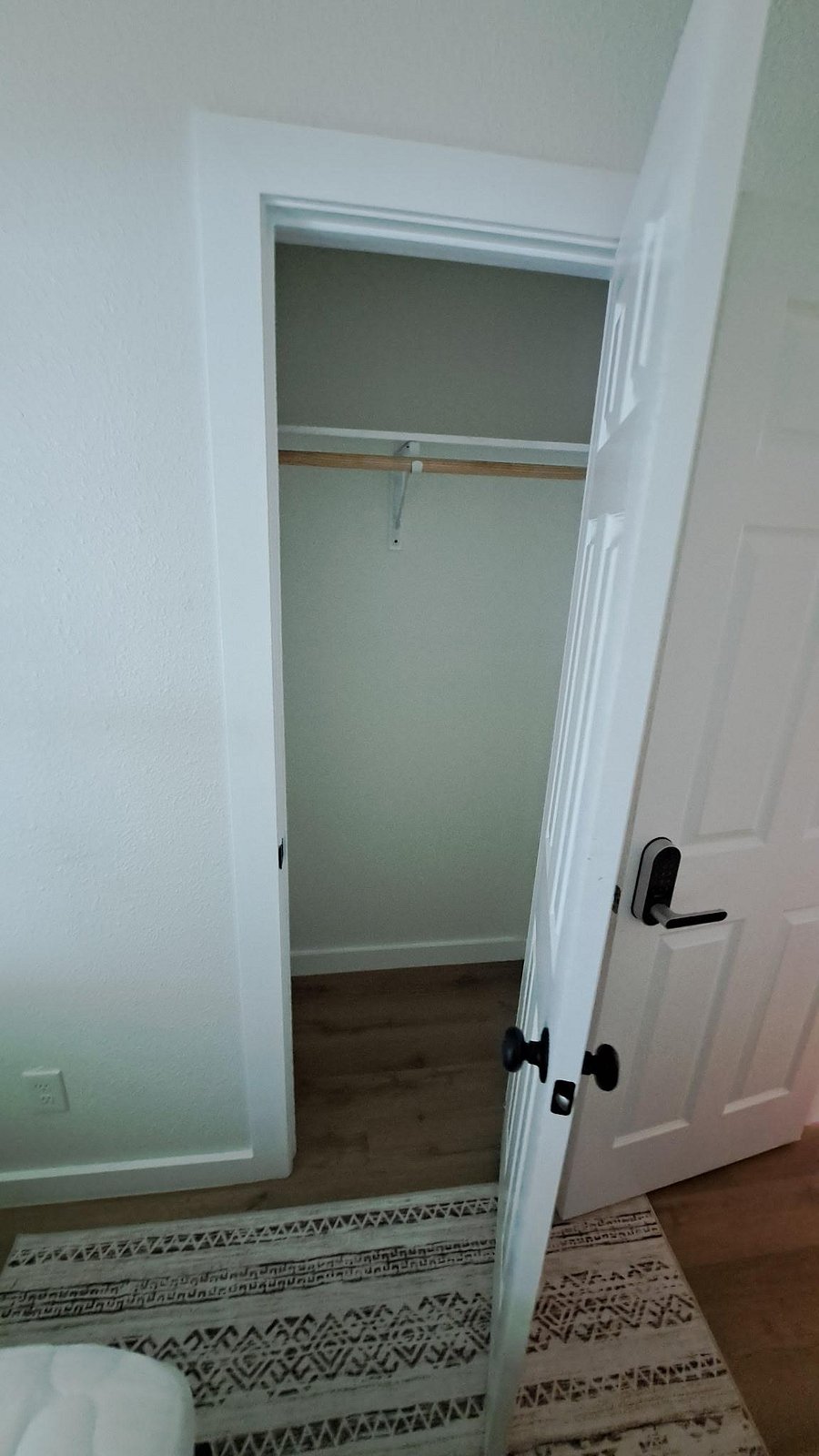 Dedicated closet with hanging rod and upper shelf offers practical storage for clothing and everyday essentials.