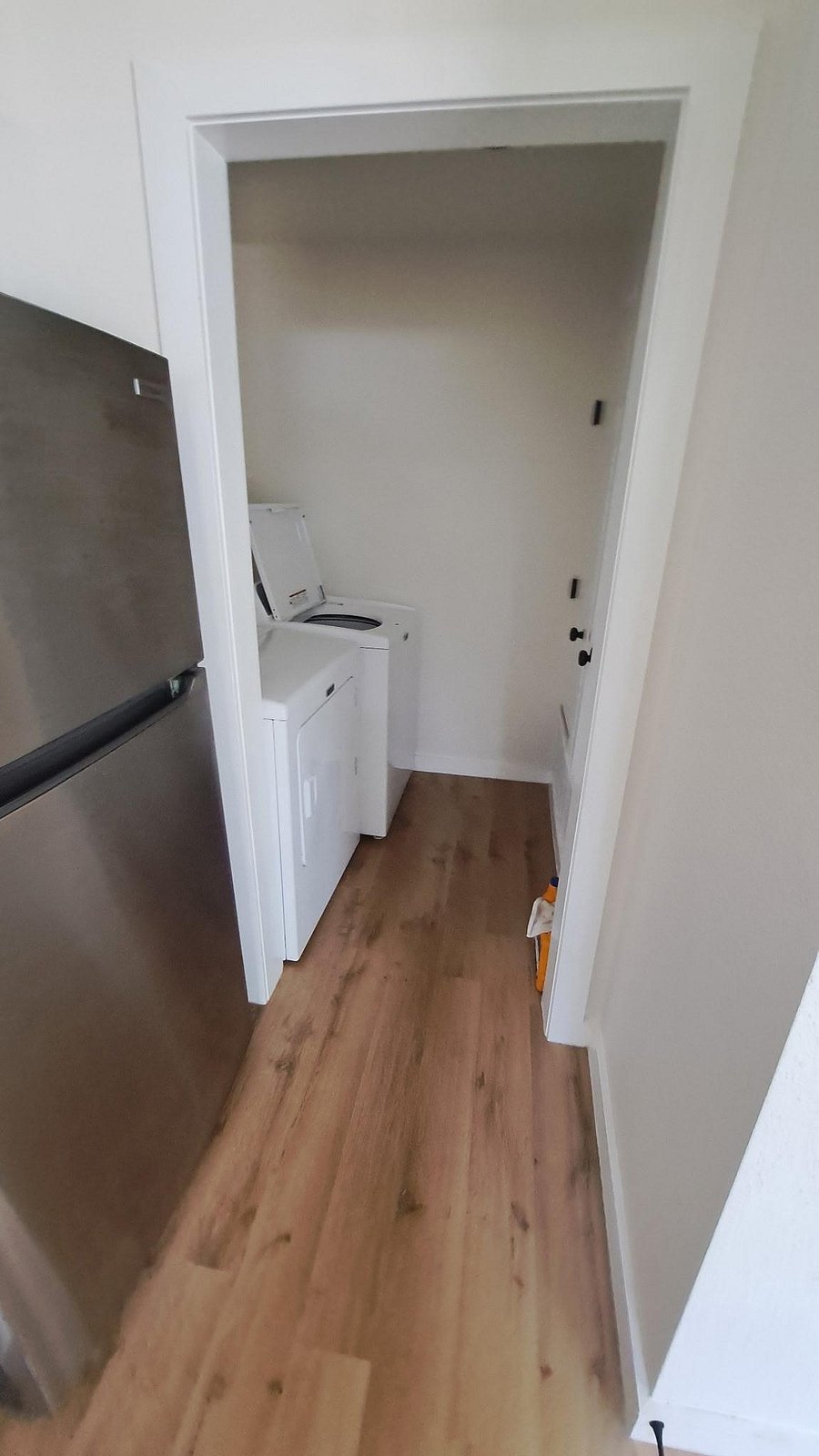 Dedicated laundry nook with in-home washer and dryer, conveniently located off the main living area for easy access.
