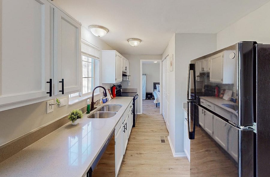 Kitchen with refrigerator stove microwave cabinets and pantry