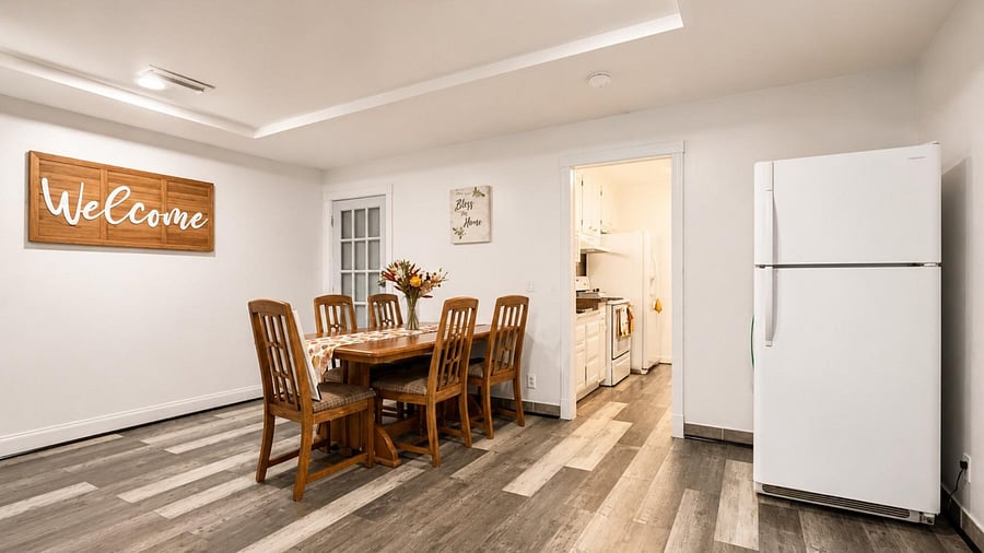 Dedicated dining area with a  table and easy access to the kitchen and 2 full-size refrigerators.
