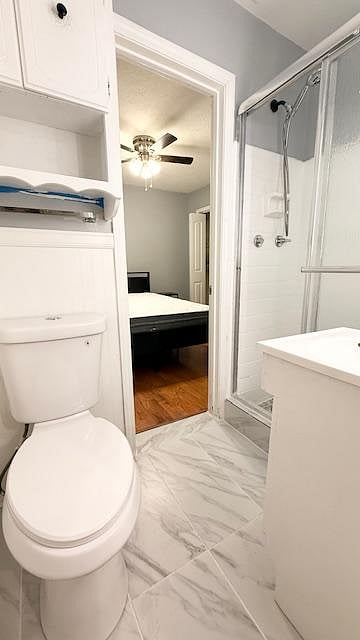 Full bathroom with tiled shower that is shared between Room 3 and 4