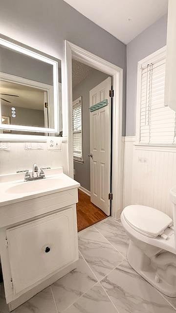 Full bathroom with tiled shower that is shared between Room 3 and 4