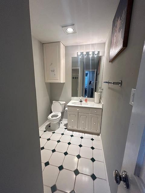 Shared bath has cabinetry for storage and a step-in shower.
