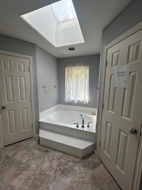 Private master suite bath tub, shower and walk-in closet.
