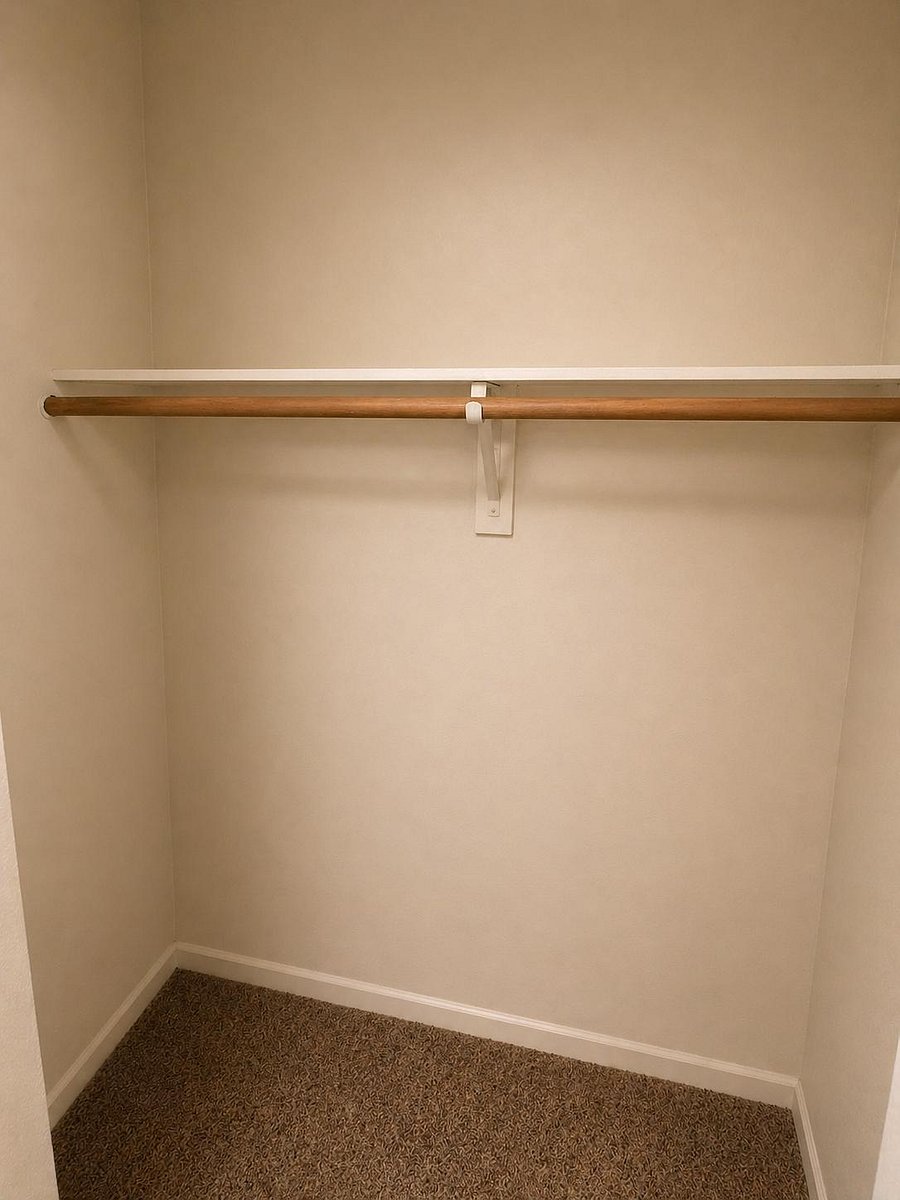 Dedicated closet space with a hanging rod and shelf to keep clothing and essentials organized and easy to access.