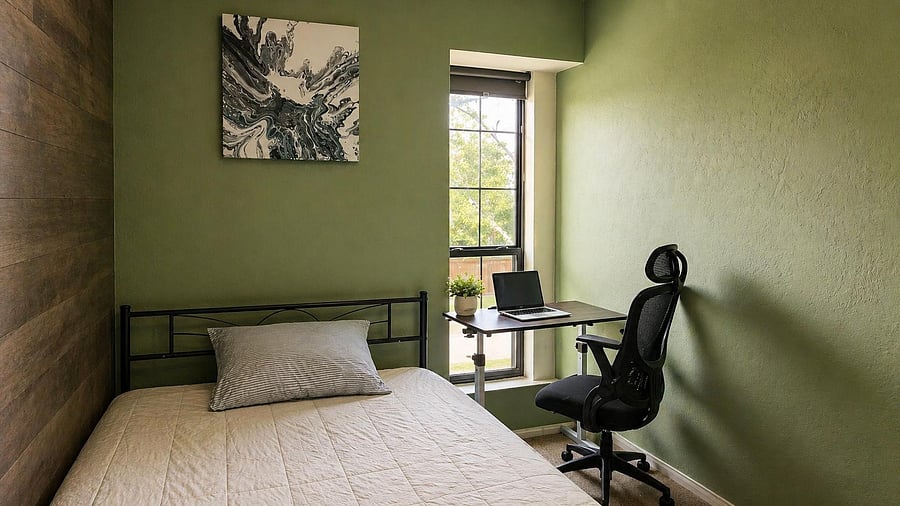Private bedroom with a comfortable bed, dedicated desk workspace, and a large window bringing in natural light.