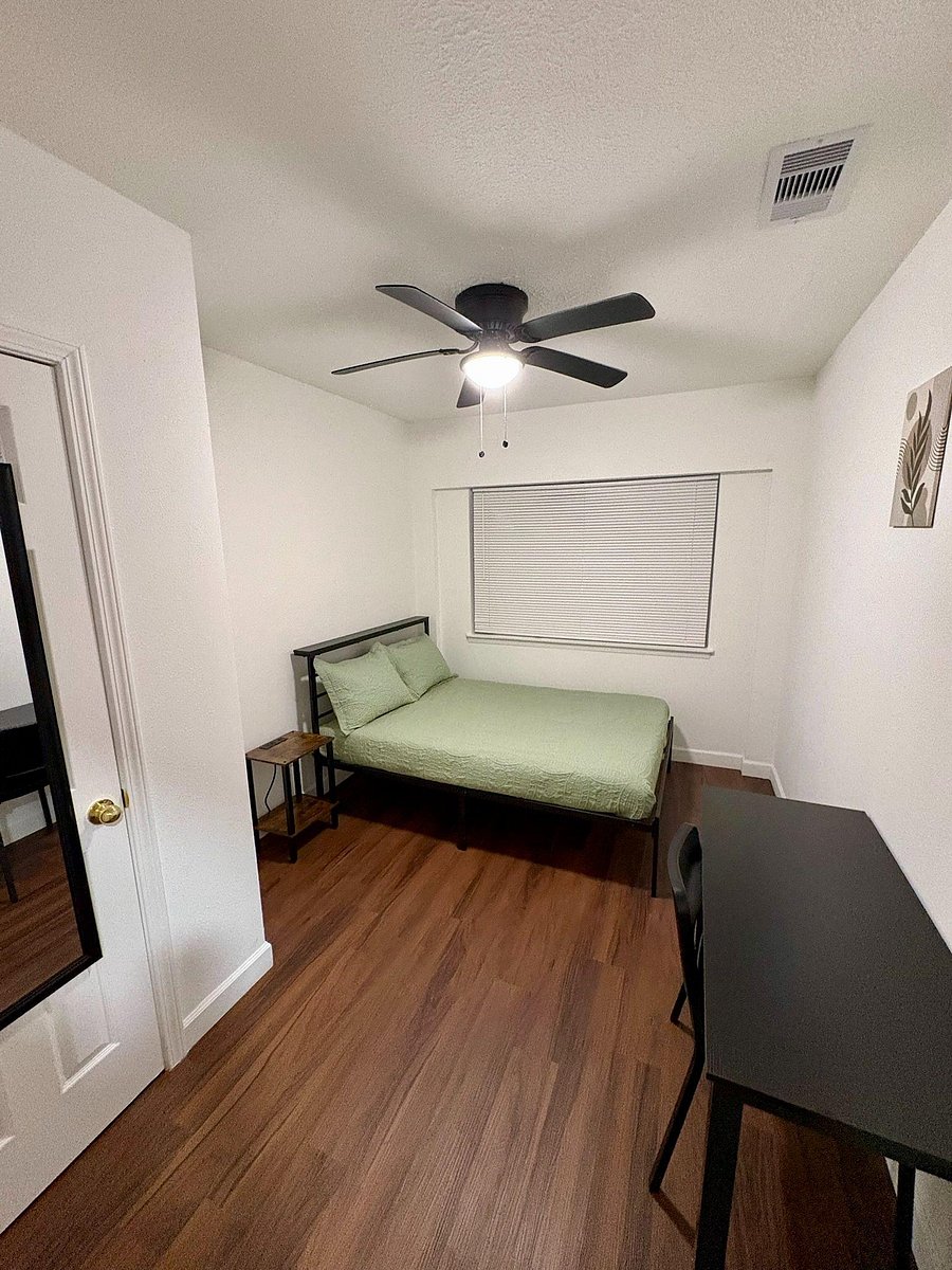 Room 6 features a full size bed, reach in closet, bedside table with a charging station, and a work station.