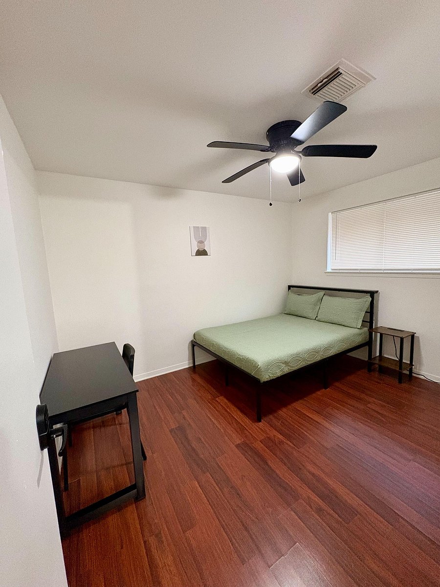 Room 2 features a full size bed, reach-in closet, bedside table with a charging station, and a work station.