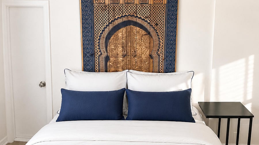Neatly furnished bedroom featuring a comfortable full bed, bedside table, and wall art for a relaxing retreat.