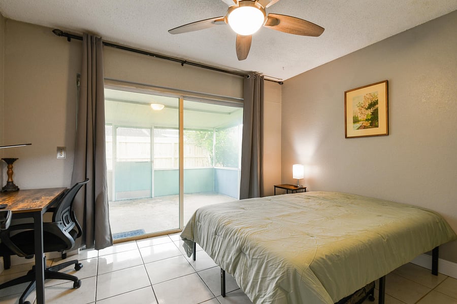 Full size cozy bed, with end table, light and storage container under the bed.  Black out curtains for your own sliders