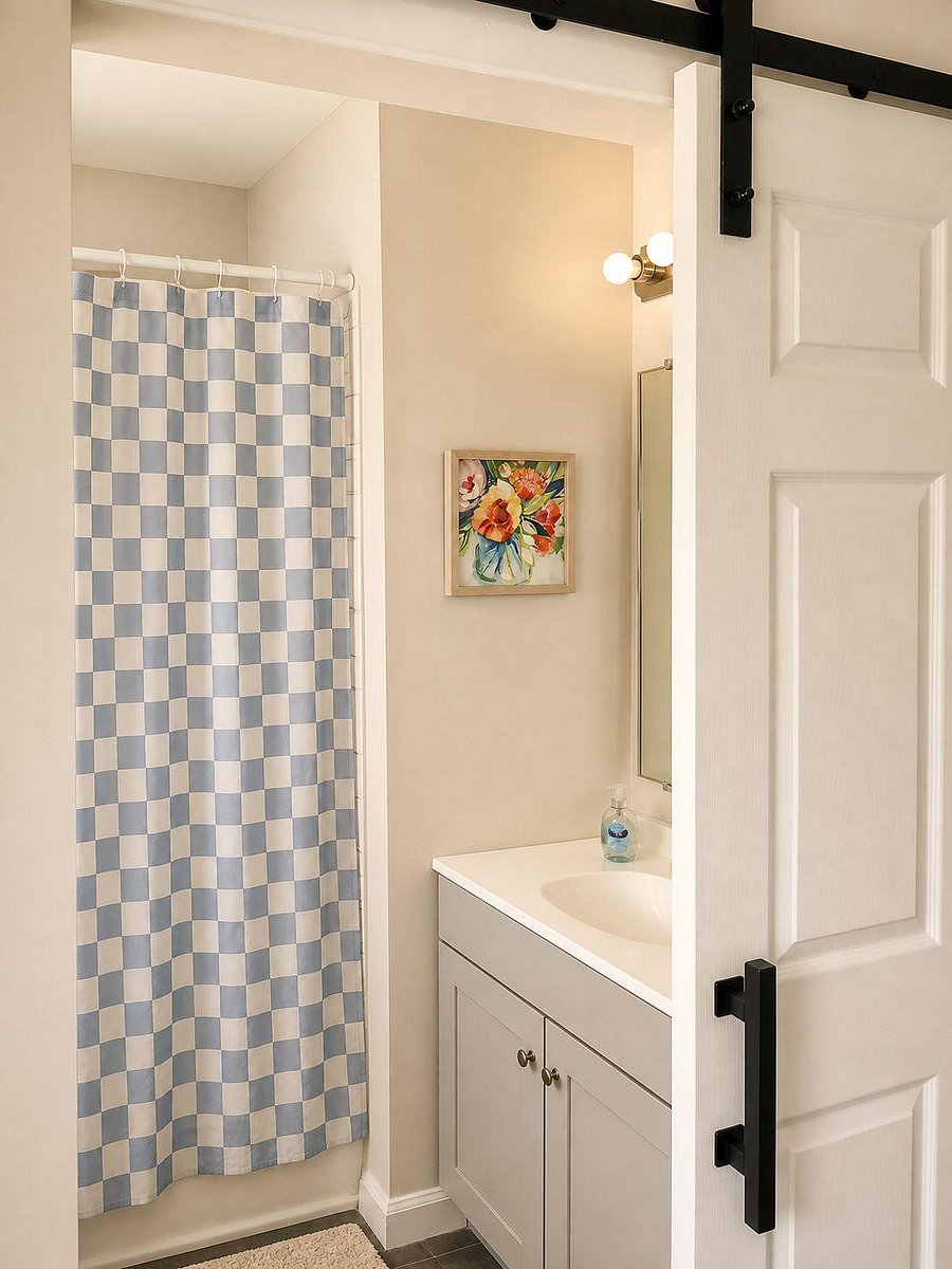 Bathroom with a tub/shower combo, vanity with under-sink storage, and updated fixtures for everyday convenience.