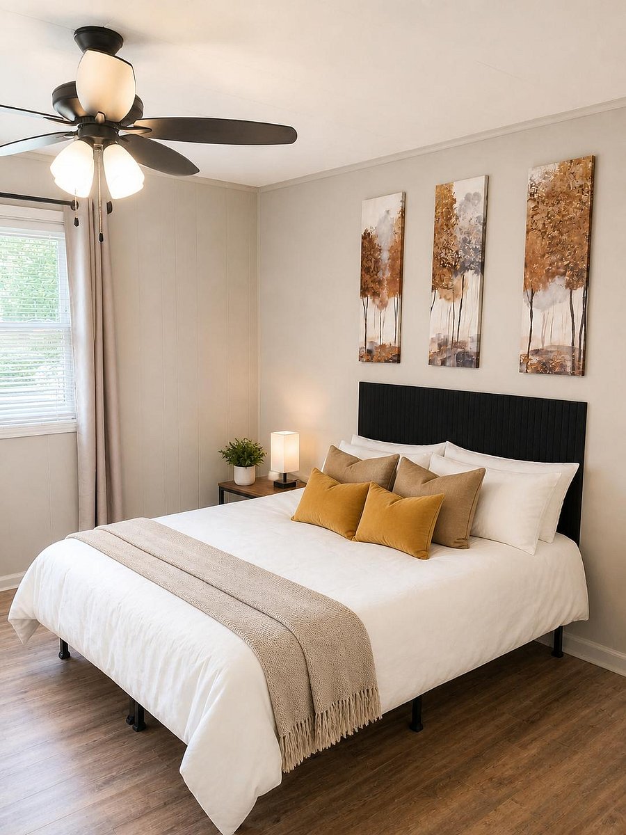 Bedroom features a comfortable bed setup, ceiling fan light, block out drapes with blinds on windows