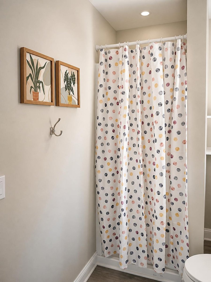 Full bathroom with a shower, updated flooring, and built-in open shelving for linens and toiletries.