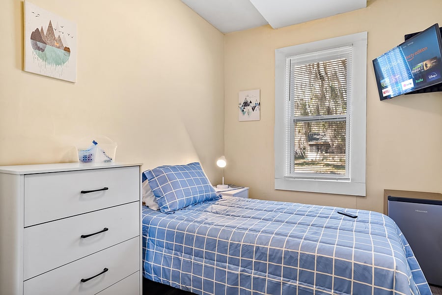 Room 6 comes with full bed, linens, TV, mini fridge, desk, chair, nightstand, clothing rack, dresser