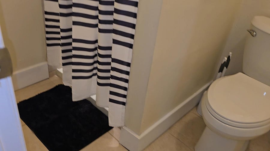 Bathroom B FULL bathroom equipped with a full shower, toilet paper, paper towel, and secure door locks for added privacy