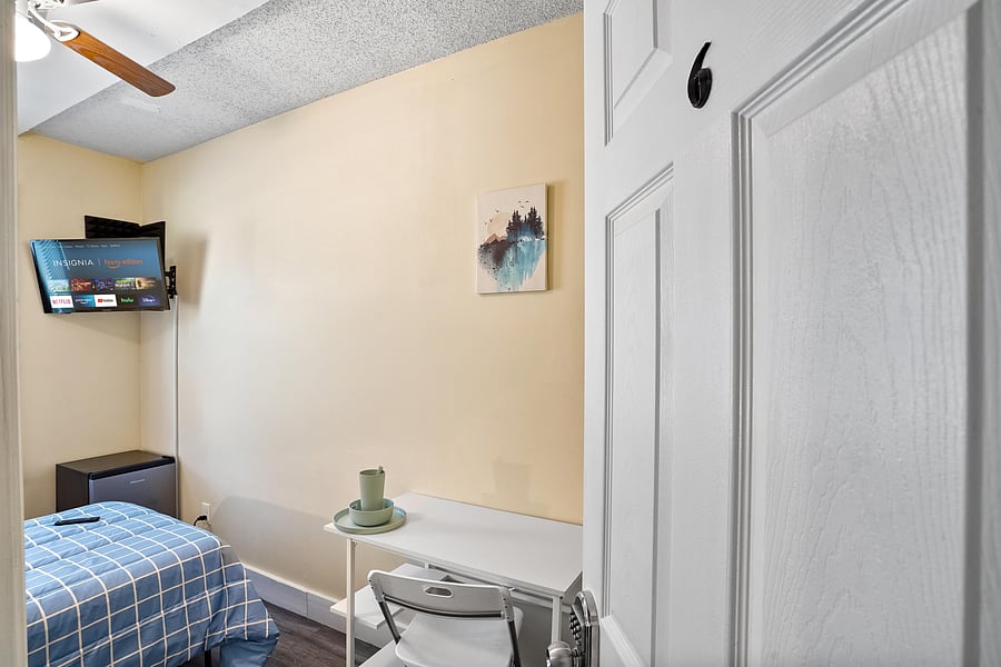 Room 6 comes with full bed, linens, TV, mini fridge, desk, chair, nightstand, clothing rack, dresser