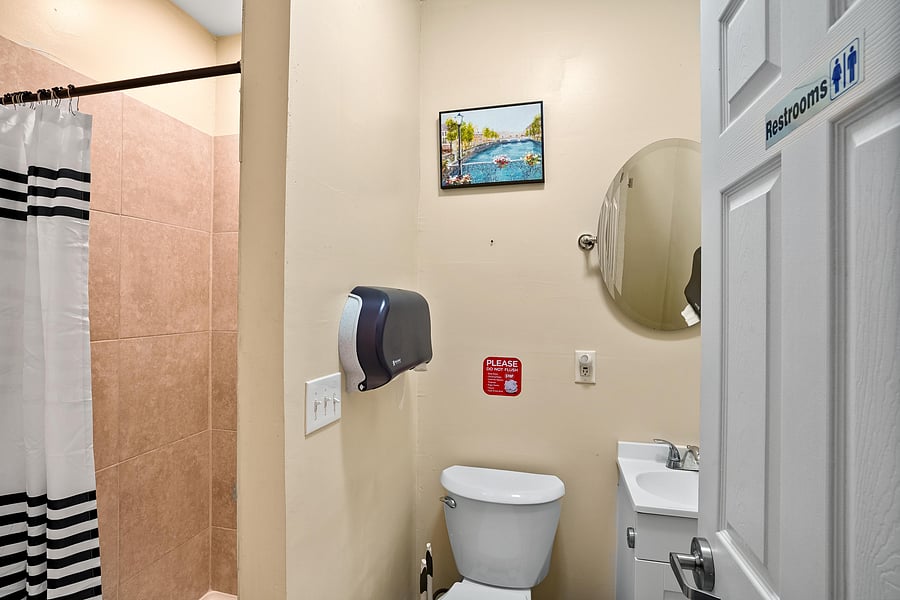 Bathroom B is equipped with a full shower, a toilet, sink. Toilet paper and paper towels provided.