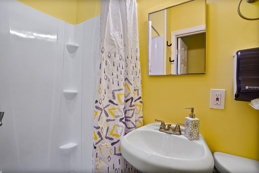 Bathroom C is equipped with, a tub, a toilet, sink. Toilet paper and paper towels provided.