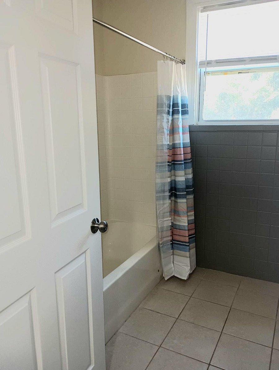 Bathroom A FULL bathroom equipped with a tub, full shower, toilet paper, paper towel, and secure door locks for added privacy