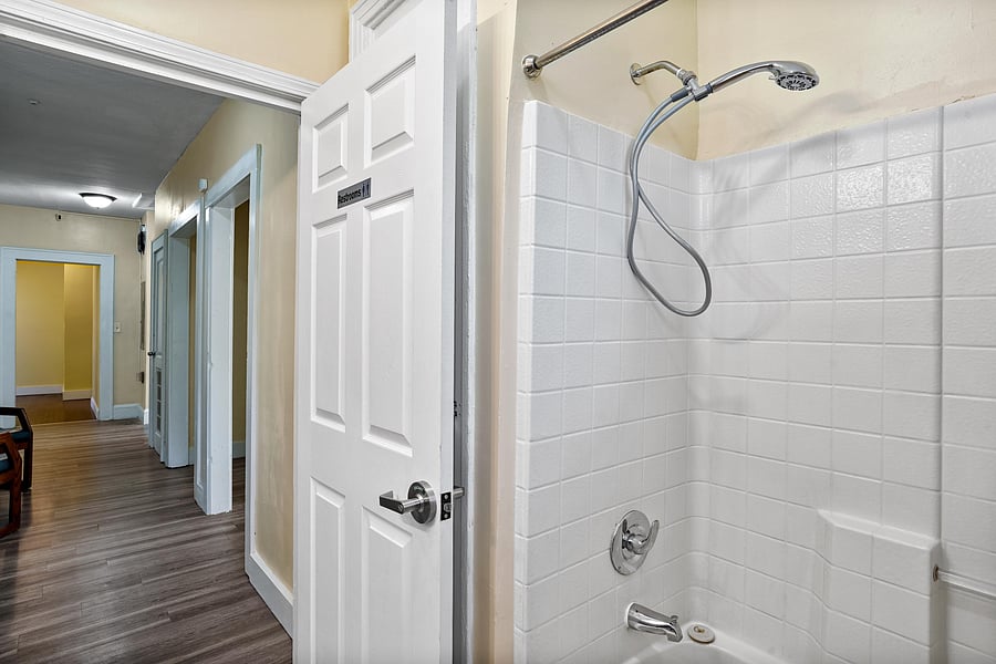 Bathroom A FULL bathroom equipped with a tub, full shower, toilet paper, paper towel, and secure door locks for added privacy