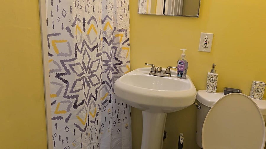 Bathroom C FULL bathroom equipped with a full shower, toilet paper, paper towel, and secure door locks for added privacy