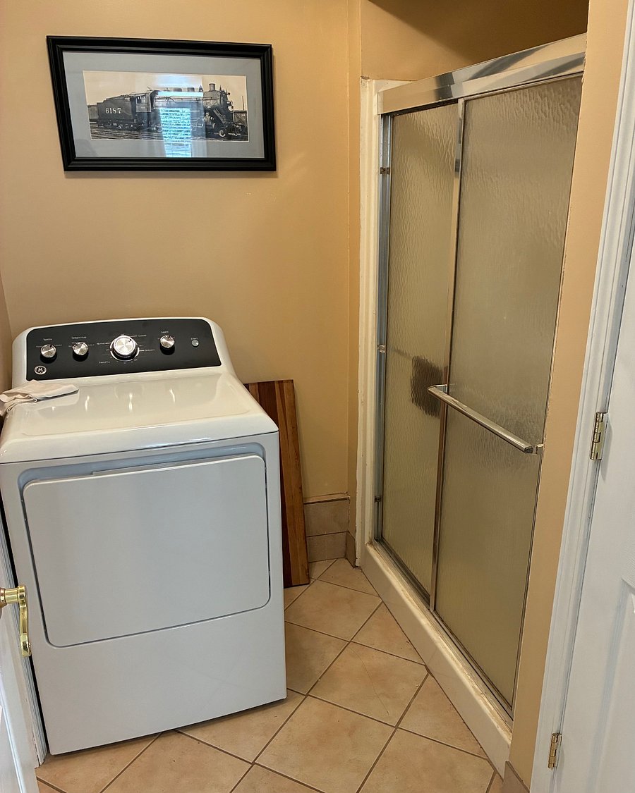 Full size dryer, walk in shower with glass sliding doors. 