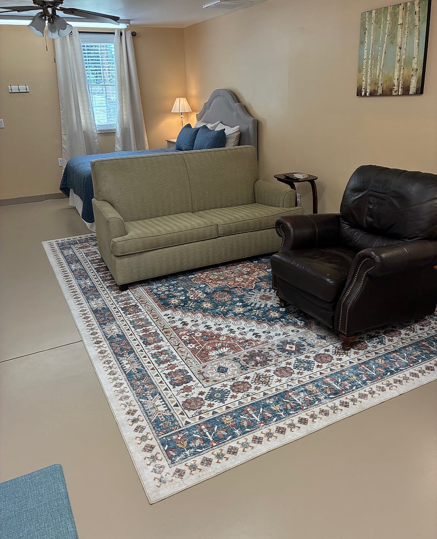Living area with love seat, very comfortable recliner and plenty of lighting. 