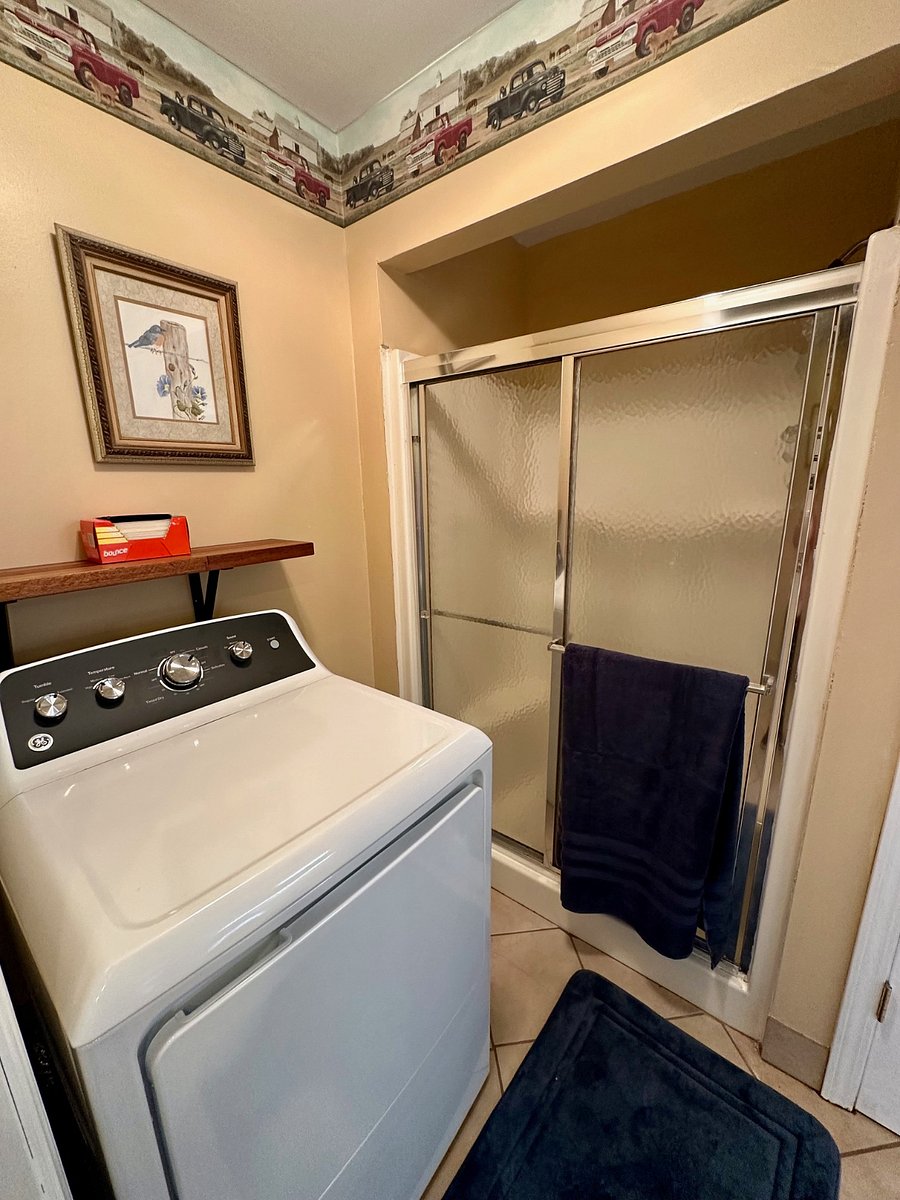 Full size gas dryer.  Walk in shower with glass doors. 
