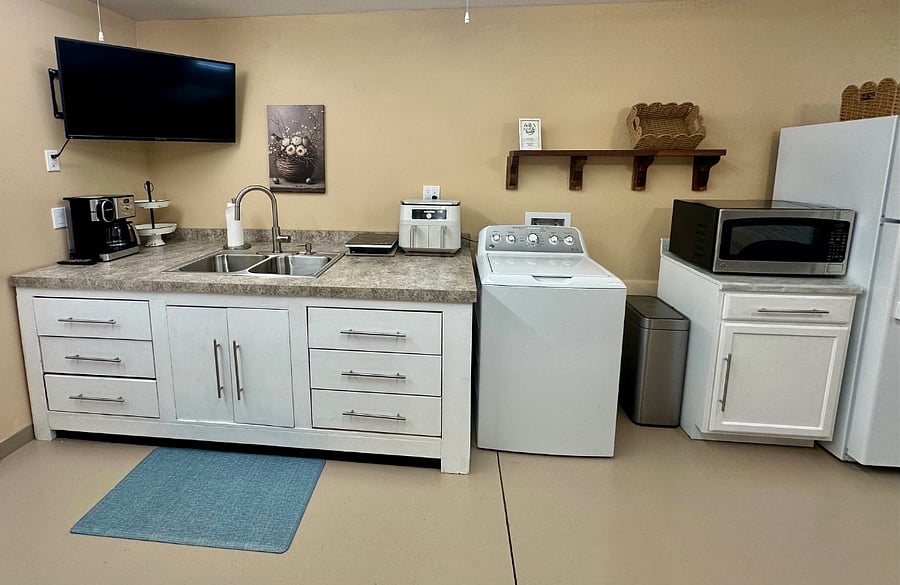 Kitchentte area has new coffee maker, airfyer, new microwave & hot plate.  Double sink and stocked with dishes, cups, silverware, etc. 