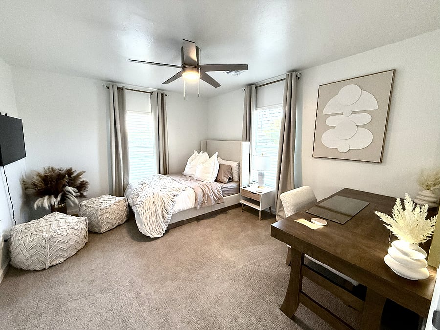 Smallest upstairs bedroom with side table, dressing vanity & mirror, 32 inch smart tv, ceiling fan, & closet
