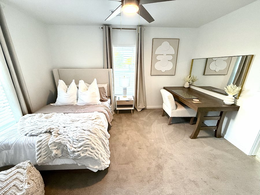 Smallest upstairs bedroom with side table, dressing vanity & mirror, 32 inch smart tv, ceiling fan, & closet