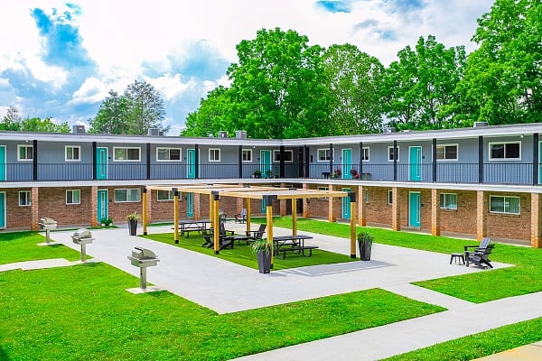 Beautiful courtyard with a pergola and quality outdoor furniture. Community gas grilling stations