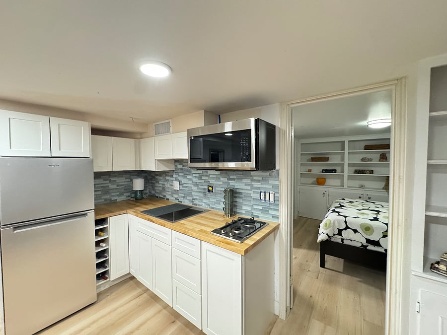 Kitchenette and door to the bedroom.
Appliances, utensils and large microwave/convection oven
