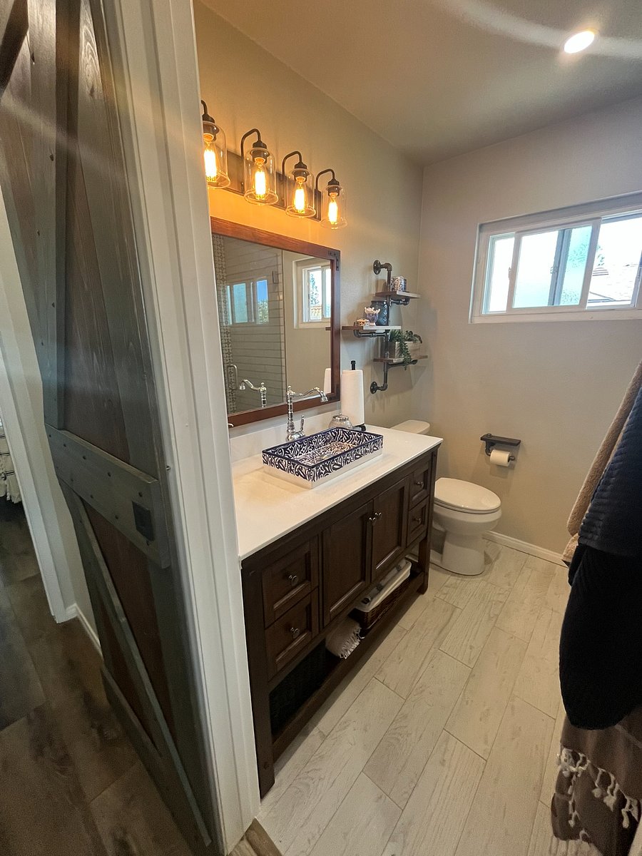 Full bathroom with Moroccan sink, lots of in-wall, under counter and over toilet storage. Doubled headed shower that is tiled with hand painted Spanish tiles.