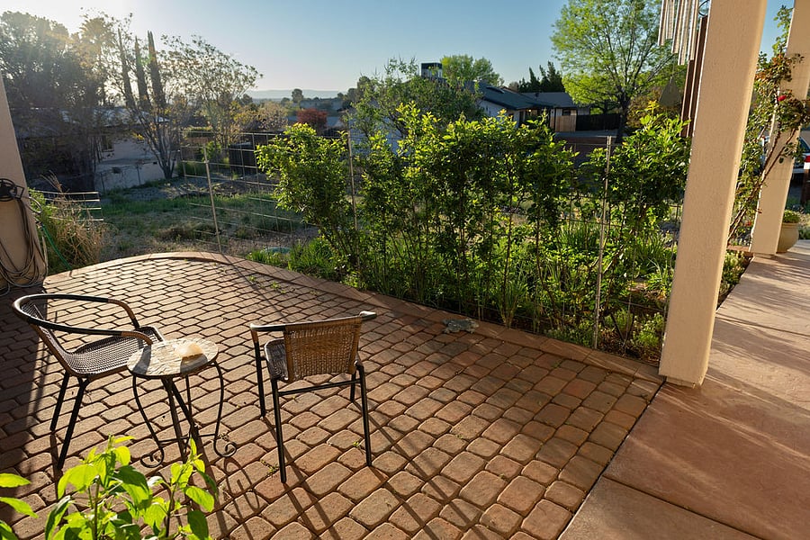 front porch view of sunrise features white rose boarder

