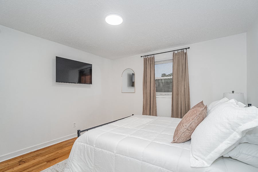 Primary bedroom suite with queen bed and half bath
