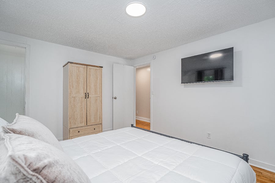 Primary queen bedroom suite with half bath