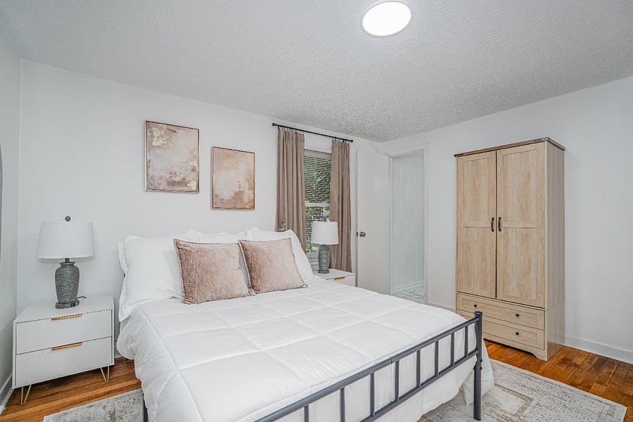Primary queen bedroom suite with half bath