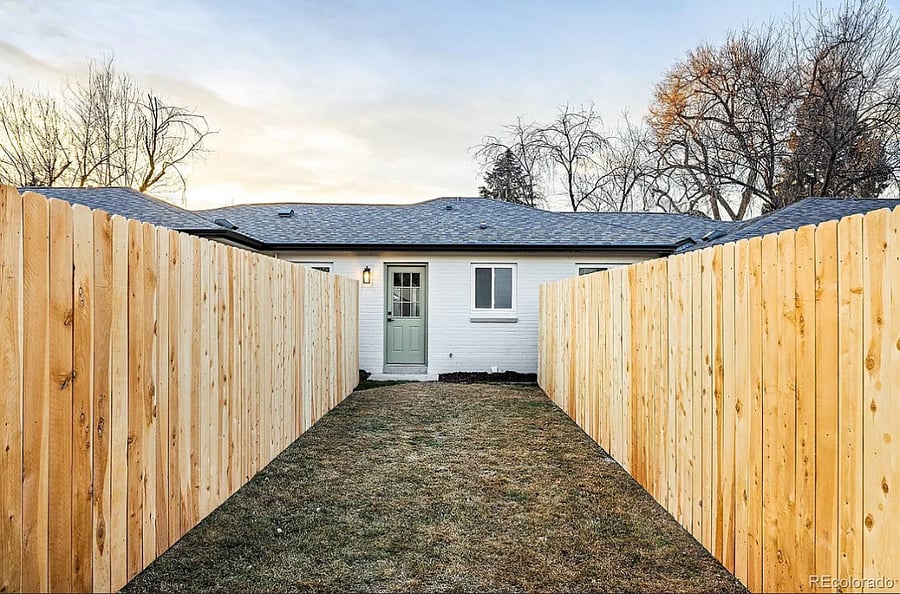 Fenced in backyard w fire pit and seating area